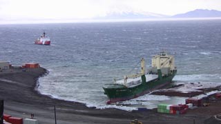 The icebreaker attempting to approach the cargo ship