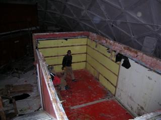 looking down from the top of the stairs into the first floor