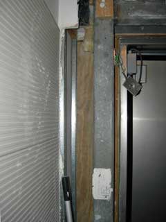 alongside the left door jamb