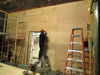 adding plywood to the wall