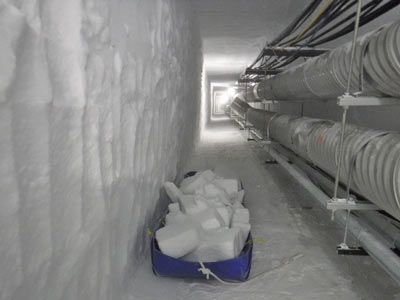 cut snow blocks loaded onto a sled