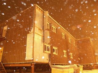 Building 211 with siding blown off