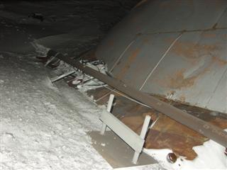 the blown off roof next to a fuel pipeline