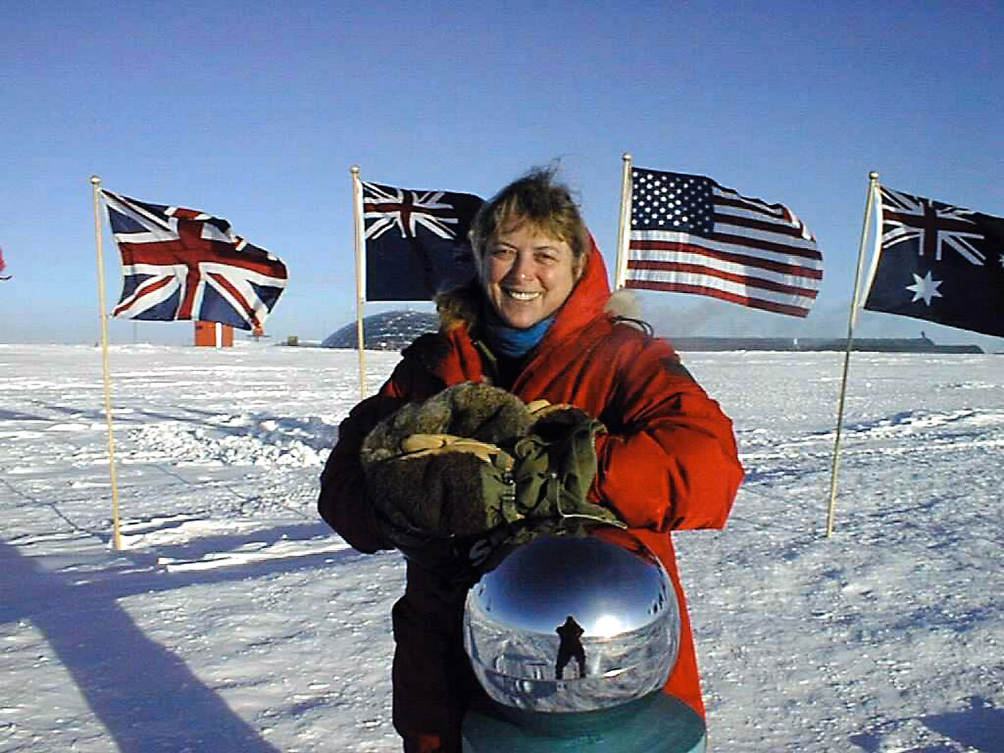 Photo of physican at the ceremonial South Pole marker.