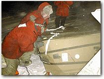 Personnel work to recover dropped bundles
