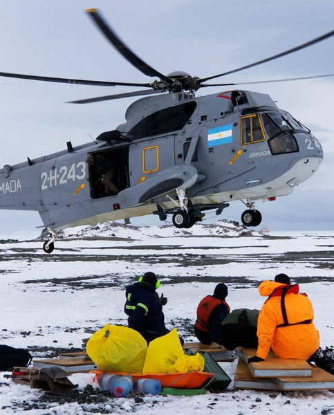 science team waits for a helicopter pickup