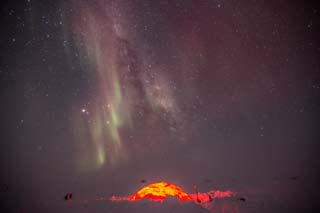 the igloo with auroras overhead
