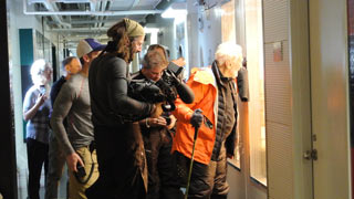 Buzz Aldrin peers into the growth chamber