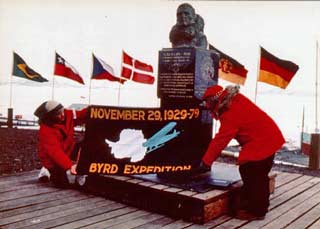 Laurence M. Gould displaying the 50th anniversary banner of Byrd's flight over the Pole