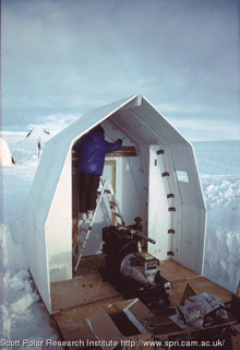 hut assembly continues; some equipment is placed