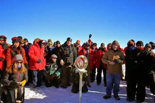 you are here, at the South Pole the assembled Polie crowd behind the marker