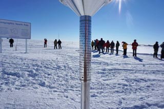 the crowd gathers behind the old Pole marker